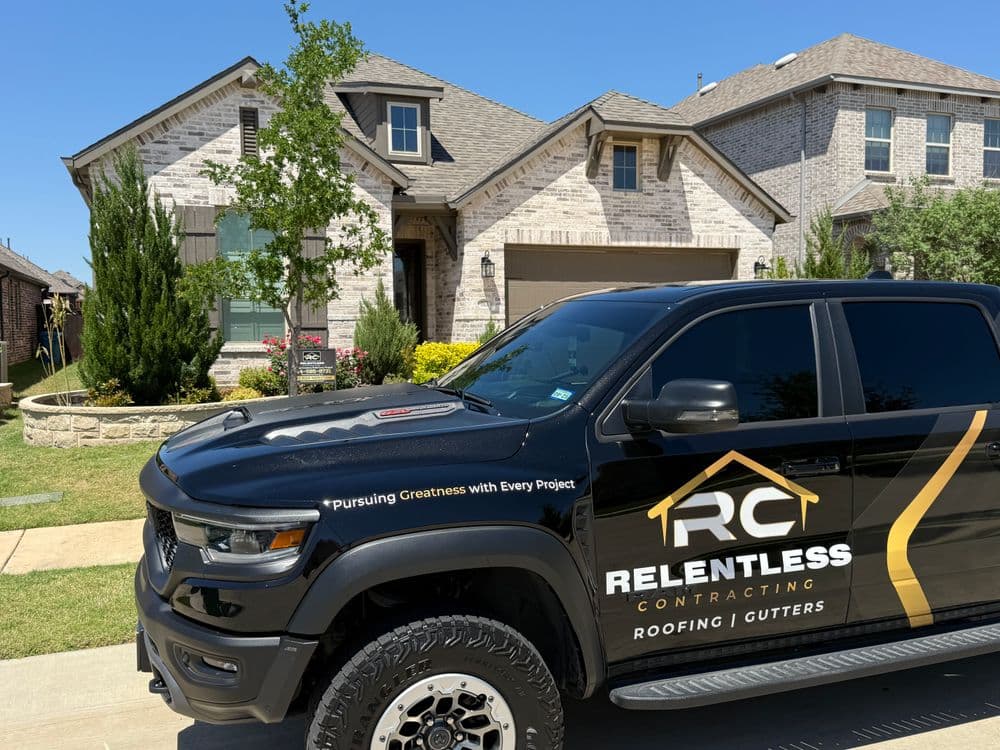Black truck with "Relentless Contracting" logo parked in front of a modern residential home.