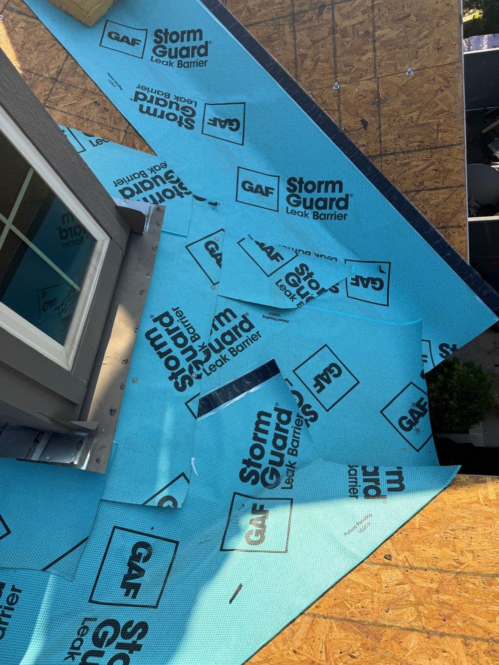 StormGuard Leak Barrier from GAF installed on a roof, showcasing blue waterproofing material.